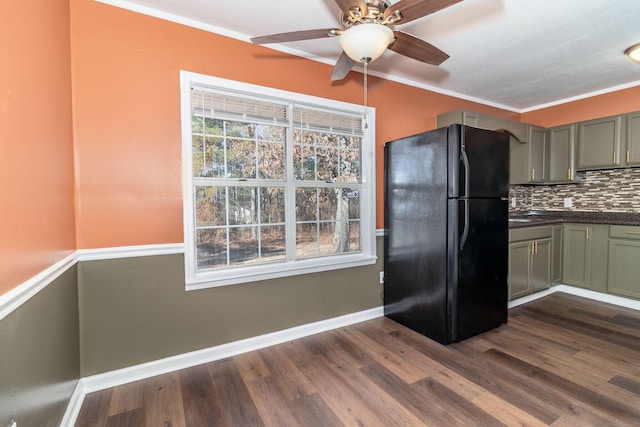 kitchen with backsplash, dark wood-type flooring, plenty of natural light, and black fridge