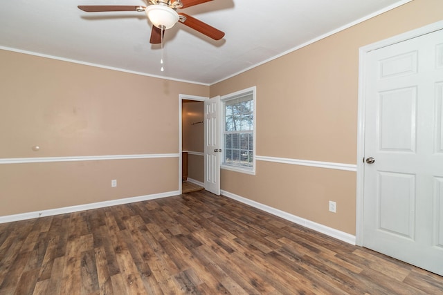 spare room featuring ornamental molding, ceiling fan, and dark hardwood / wood-style flooring