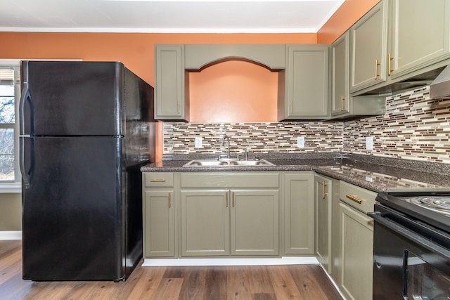 kitchen featuring tasteful backsplash, sink, black appliances, and hardwood / wood-style floors