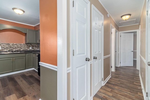 hallway with crown molding, sink, and dark hardwood / wood-style flooring