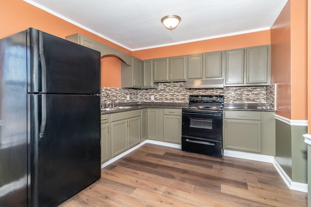 kitchen featuring sink, backsplash, light hardwood / wood-style flooring, and black appliances