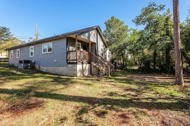 view of side of home featuring a yard