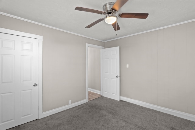 unfurnished bedroom featuring carpet floors, a closet, ceiling fan, and ornamental molding