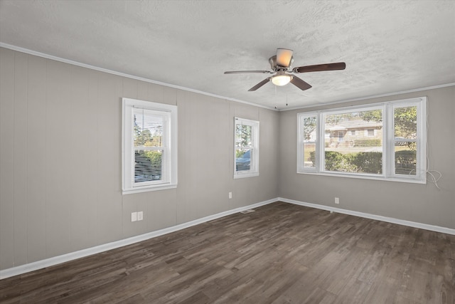 empty room featuring a textured ceiling, crown molding, ceiling fan, and dark wood-type flooring