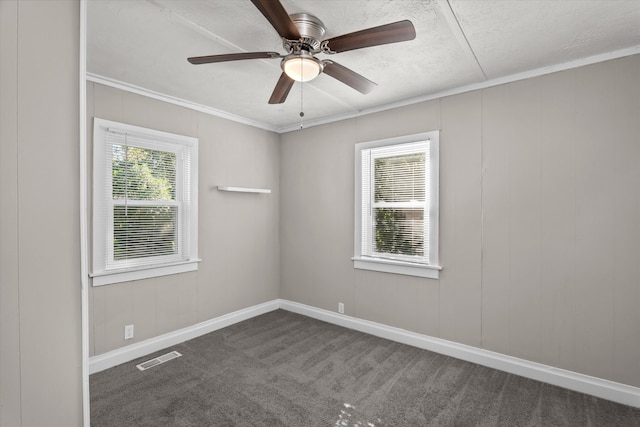 carpeted empty room featuring a textured ceiling, ceiling fan, and ornamental molding