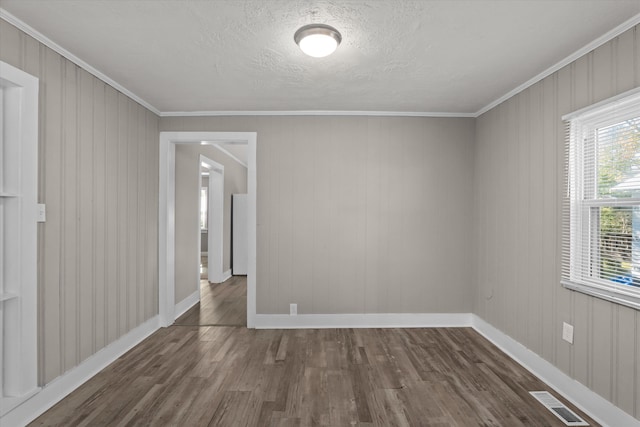 unfurnished room featuring crown molding and dark wood-type flooring