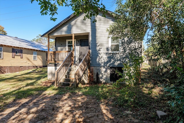 back of property featuring covered porch