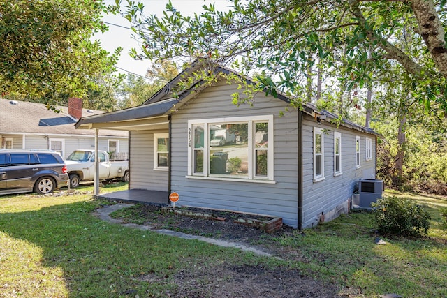 exterior space featuring a lawn and central air condition unit