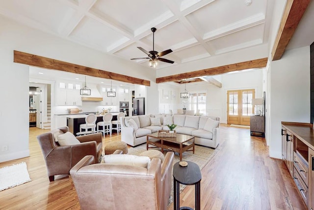 living room featuring light wood-type flooring, beam ceiling, coffered ceiling, and french doors