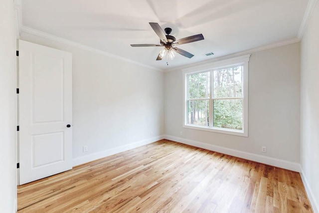 unfurnished room with ornamental molding, baseboards, visible vents, and light wood finished floors