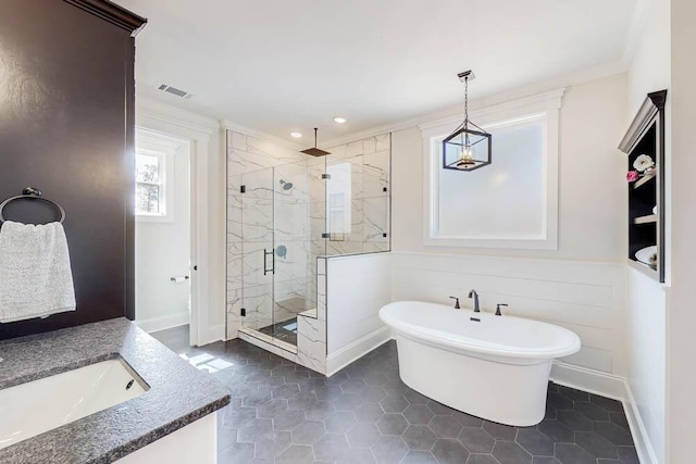 bathroom featuring vanity, visible vents, a freestanding bath, ornamental molding, and a shower stall