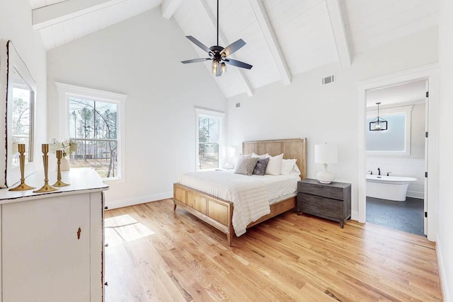 bedroom featuring visible vents, beamed ceiling, multiple windows, and light wood-style flooring