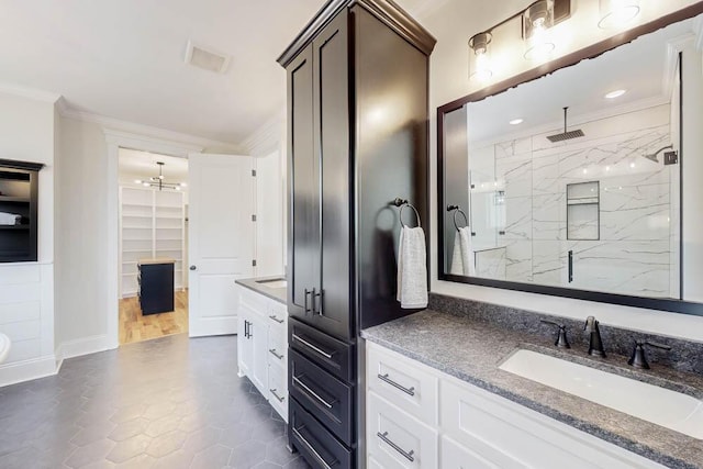 full bathroom with visible vents, a marble finish shower, ornamental molding, and vanity