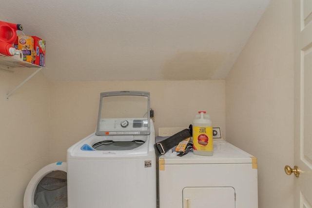 clothes washing area featuring washer and dryer