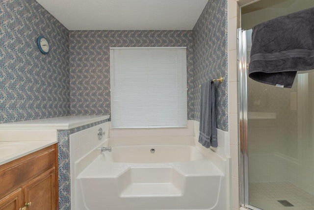 bathroom featuring vanity and independent shower and bath