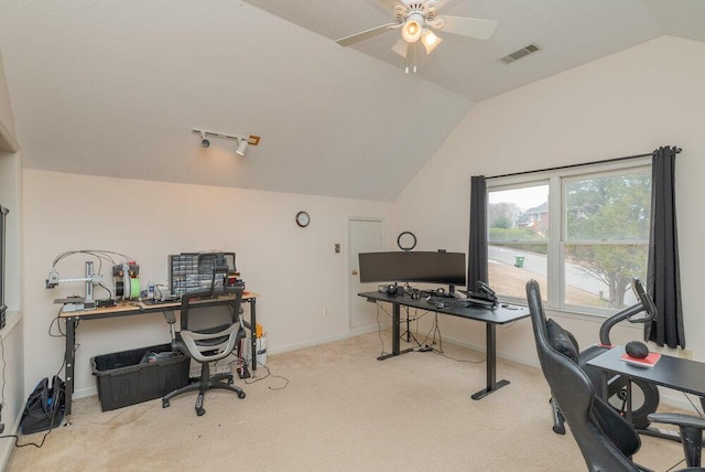 office area featuring vaulted ceiling, light colored carpet, and ceiling fan