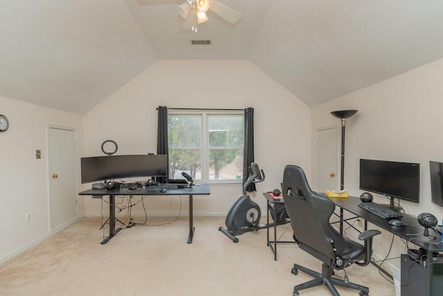 carpeted office space featuring lofted ceiling and ceiling fan