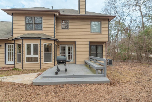 back of house featuring a deck and central air condition unit