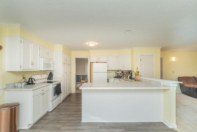 kitchen with crown molding, white cabinets, white appliances, and light hardwood / wood-style floors