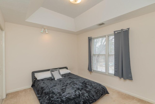 bedroom featuring light carpet