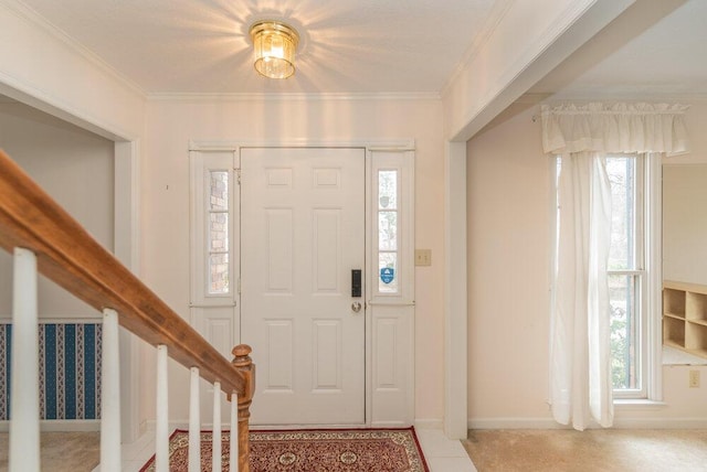 entrance foyer with crown molding and a wealth of natural light