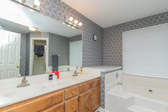 bathroom with vanity and a tub