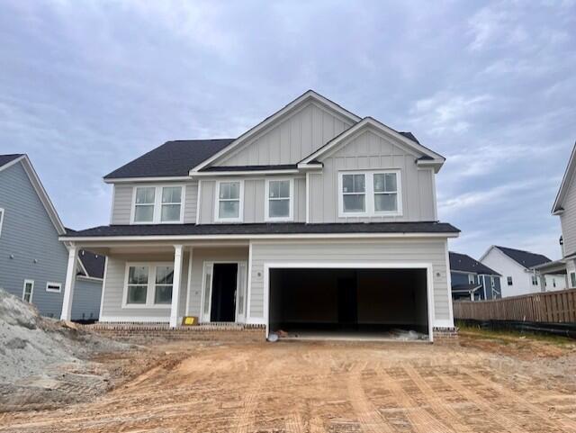 2974 Rosewood Dr, Evans, GA 30809 - view of front of property featuring board and batten siding, decorative driveway, a porch, and an attached garage