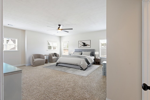 bedroom with ceiling fan, visible vents, and baseboards