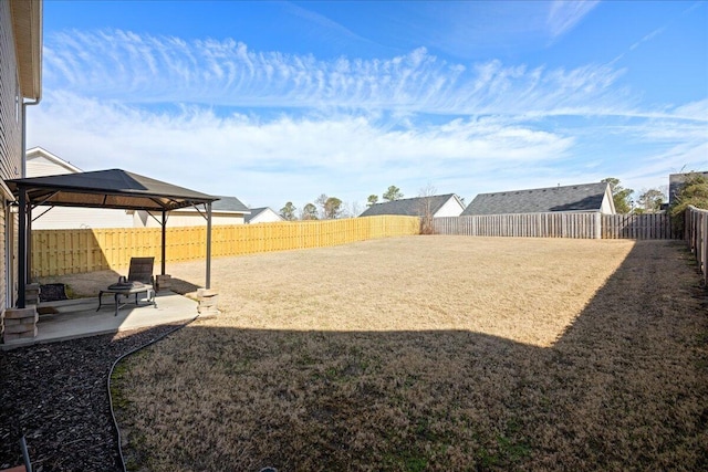 view of yard featuring a gazebo, a patio, and a fenced backyard