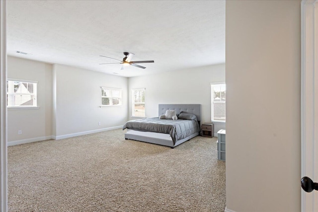 bedroom featuring carpet, visible vents, baseboards, and a textured ceiling