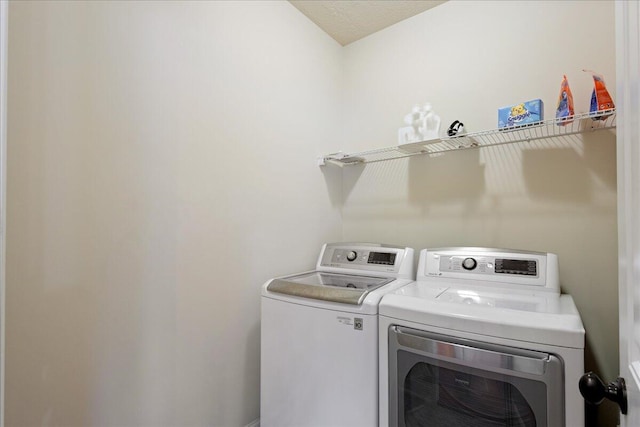 laundry area with laundry area and washer and clothes dryer