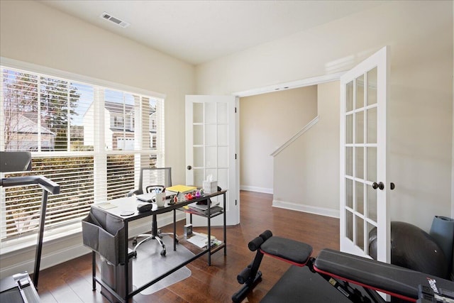 home office with french doors, wood finished floors, visible vents, and baseboards