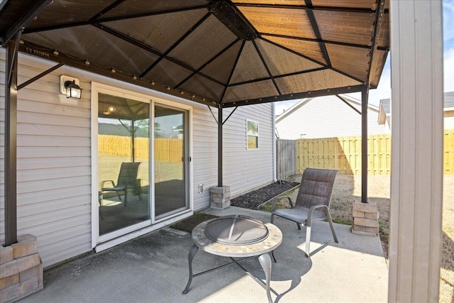 view of patio / terrace featuring an outdoor fire pit and fence