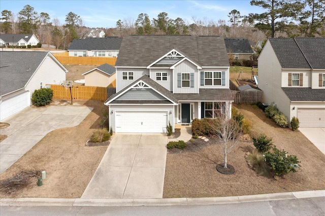 view of front of property featuring a residential view, fence, board and batten siding, and concrete driveway