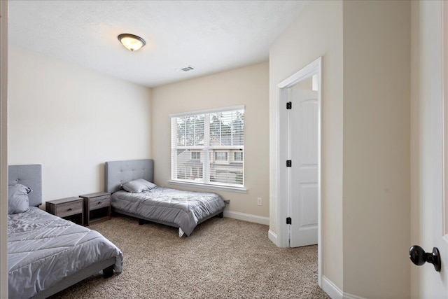 carpeted bedroom featuring visible vents and baseboards