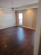 unfurnished room with ceiling fan and dark hardwood / wood-style floors