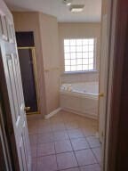 bathroom with separate shower and tub and tile patterned floors