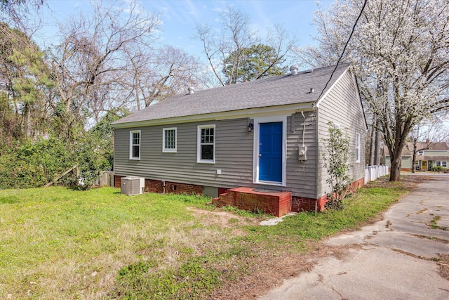 102 Oak St, Washington, GA 30673 - exterior space with central air condition unit, roof with shingles, and a front lawn