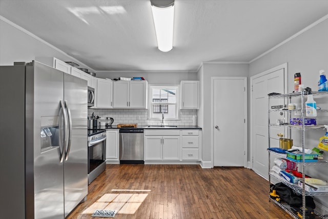 102 Oak St, Washington, GA 30673 - kitchen with dark countertops, dark wood finished floors, appliances with stainless steel finishes, white cabinetry, and a sink
