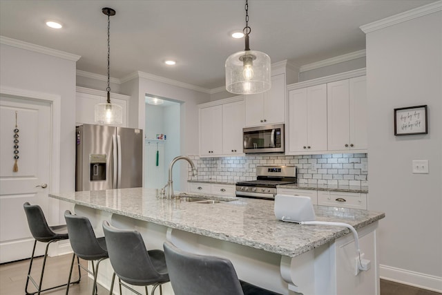 2020 Sinclair Dr, Grovetown, GA 30813 - kitchen with appliances with stainless steel finishes, a sink, backsplash, white cabinetry, and ornamental molding
