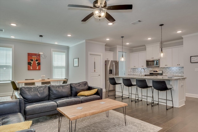 2020 Sinclair Dr, Grovetown, GA 30813 - living room with dark wood finished floors, ornamental molding, a ceiling fan, healthy amount of natural light, and baseboards