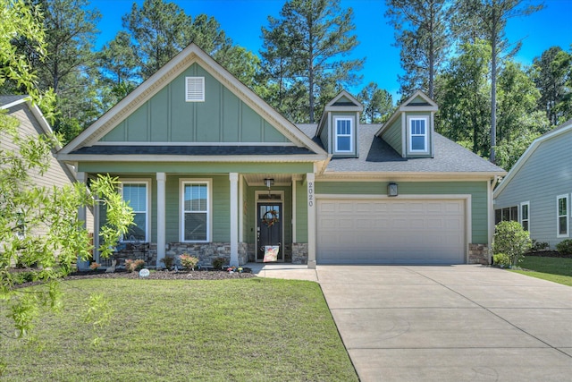 2020 Sinclair Dr, Grovetown, GA 30813 - craftsman-style home with board and batten siding, stone siding, a garage, a front lawn, and concrete driveway