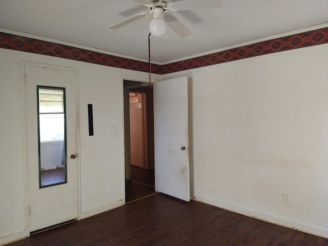 empty room with dark hardwood / wood-style flooring and ceiling fan