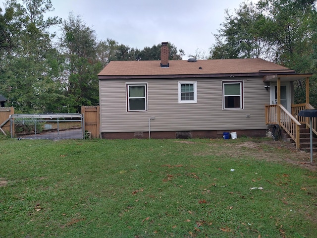 rear view of property with a lawn