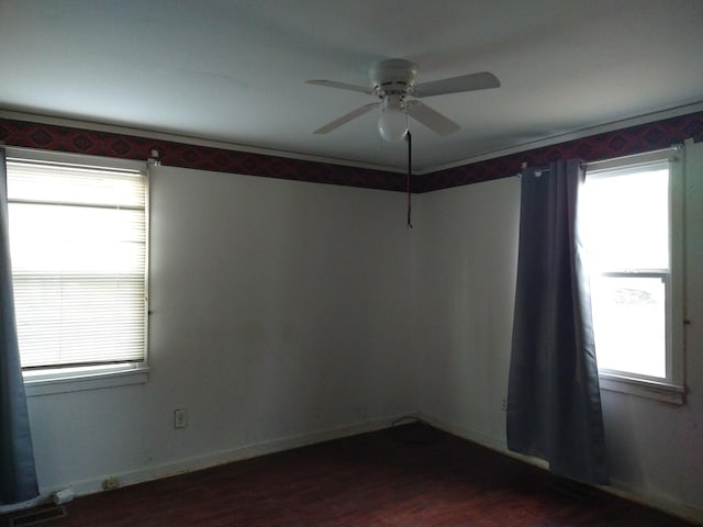 unfurnished room with ceiling fan and dark hardwood / wood-style flooring