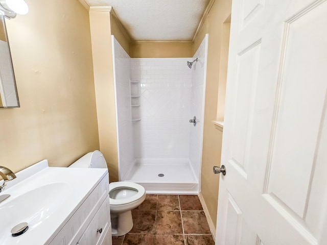 bathroom with a shower, vanity, a textured ceiling, and toilet