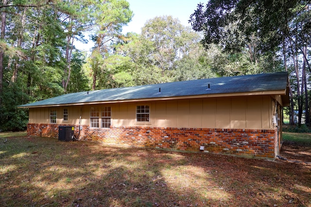 rear view of property with central AC unit