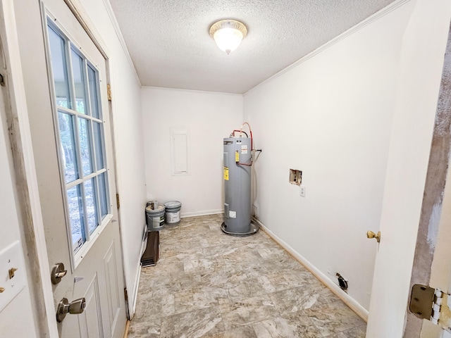 washroom featuring water heater, crown molding, washer hookup, and a textured ceiling