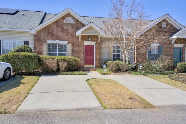 view of front of property with brick siding and a front lawn