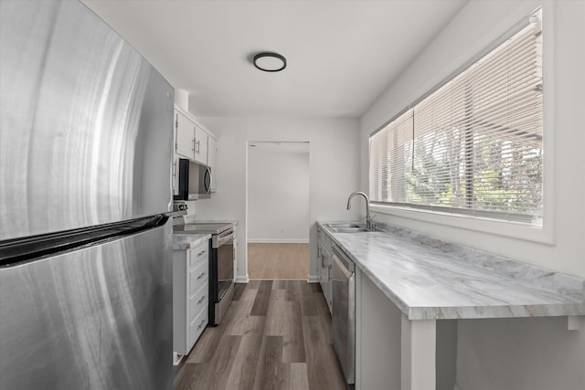 kitchen with white cabinetry, appliances with stainless steel finishes, dark wood-type flooring, and sink